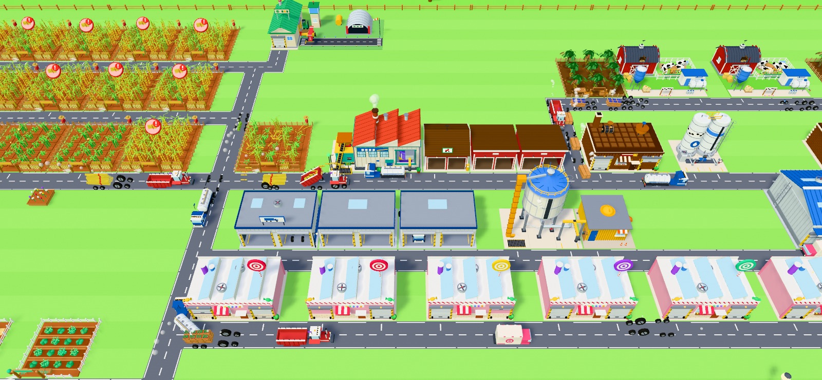 A candy works with fields, a sugar mill, factories, a warehouse and trucks on the roads